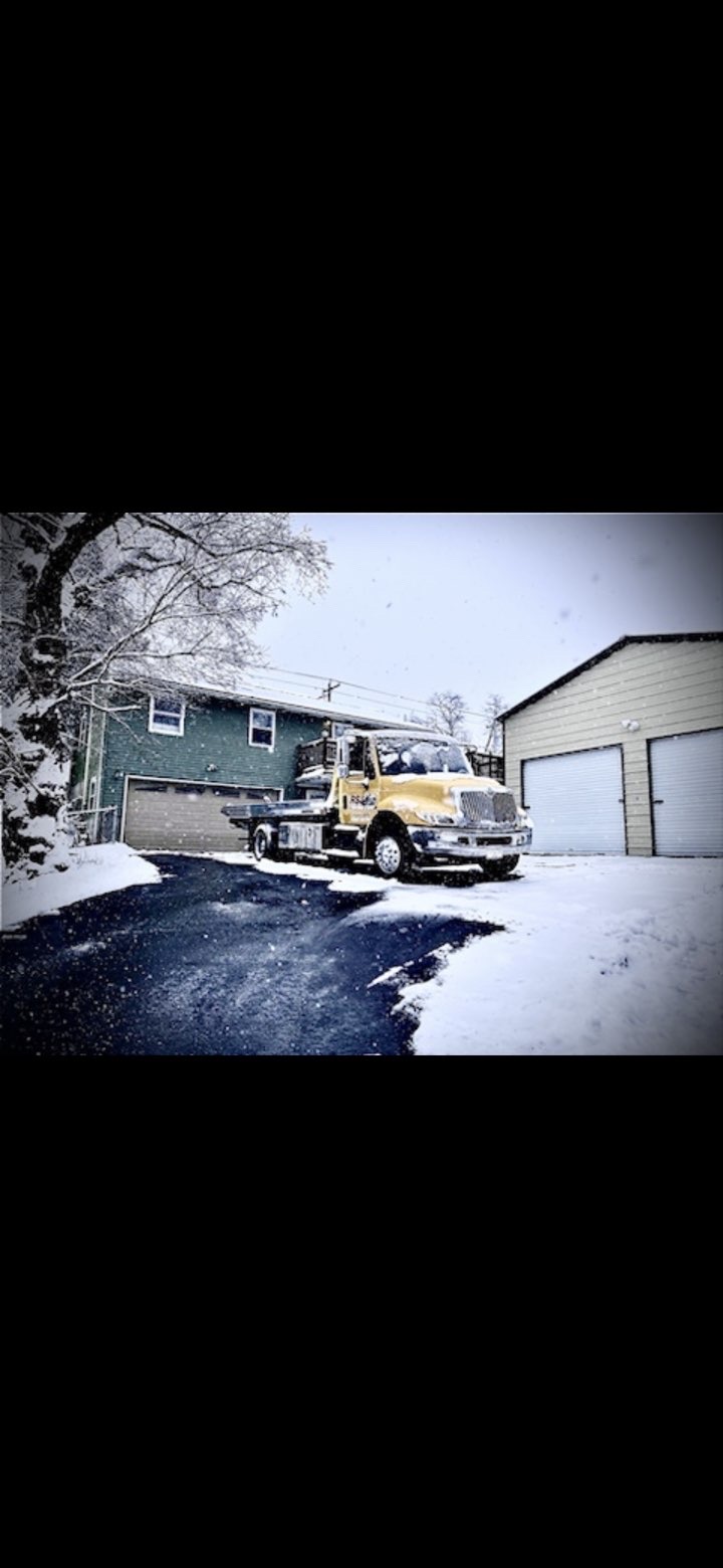 RSJ Towing truck in snowy driveway