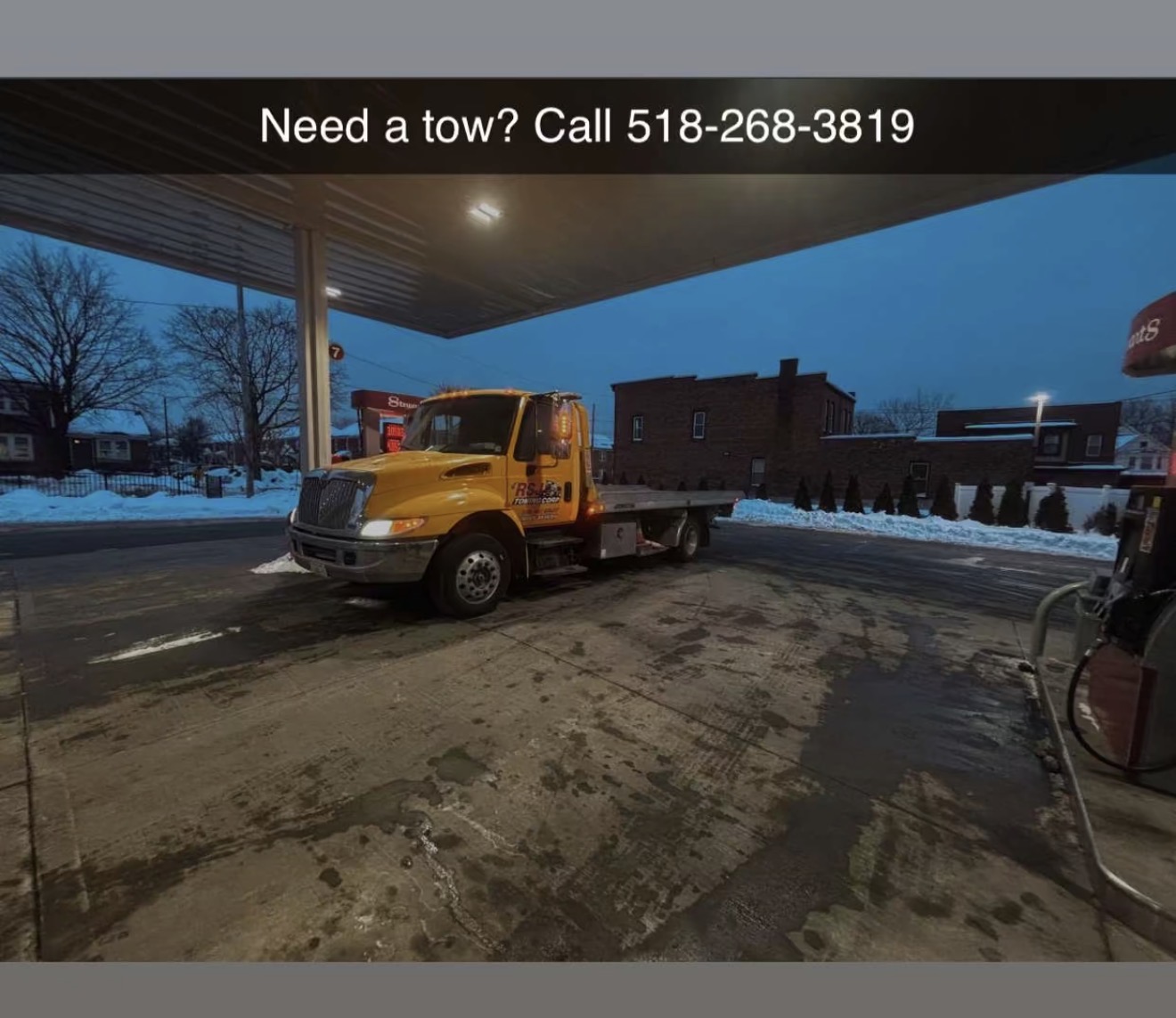RSJ Towing truck at gas station in winter